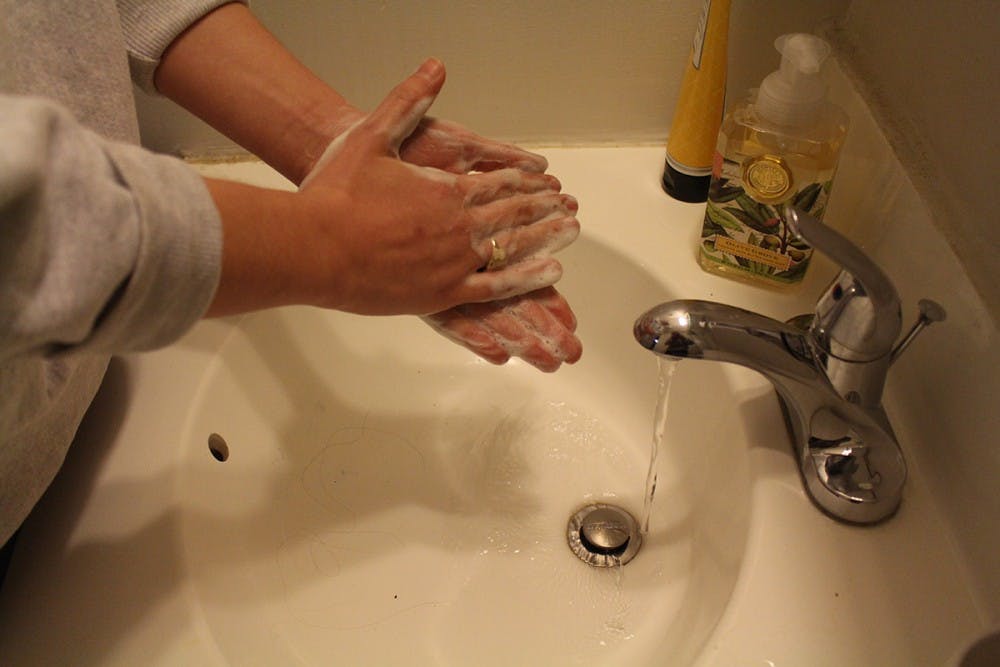 A student washes her hands