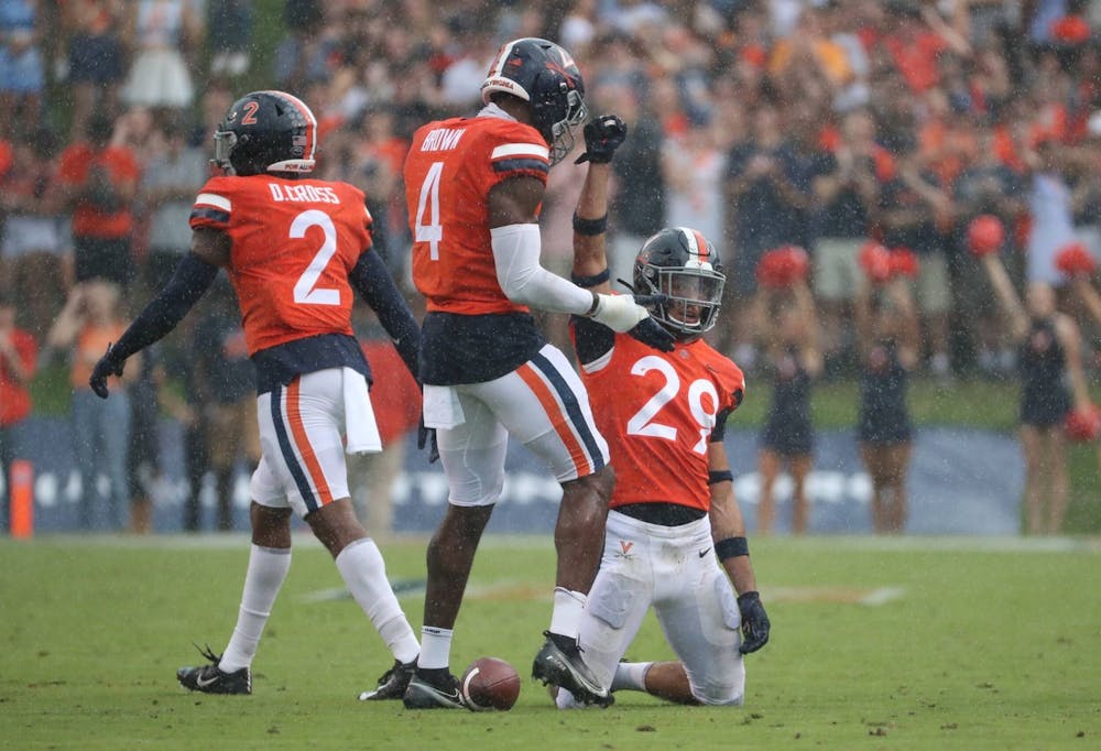 <p>The Cavaliers celebrate after forcing a stop on defense against Duke Saturday afternoon.</p>