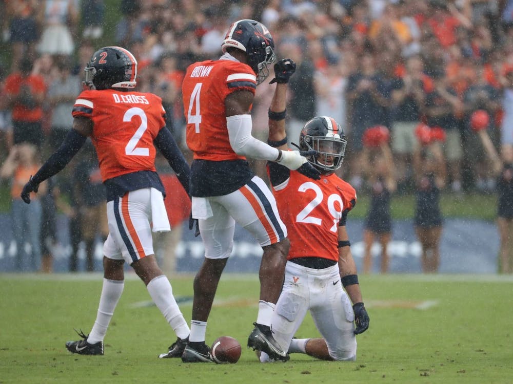 The Cavaliers celebrate after forcing a stop on defense against Duke Saturday afternoon.