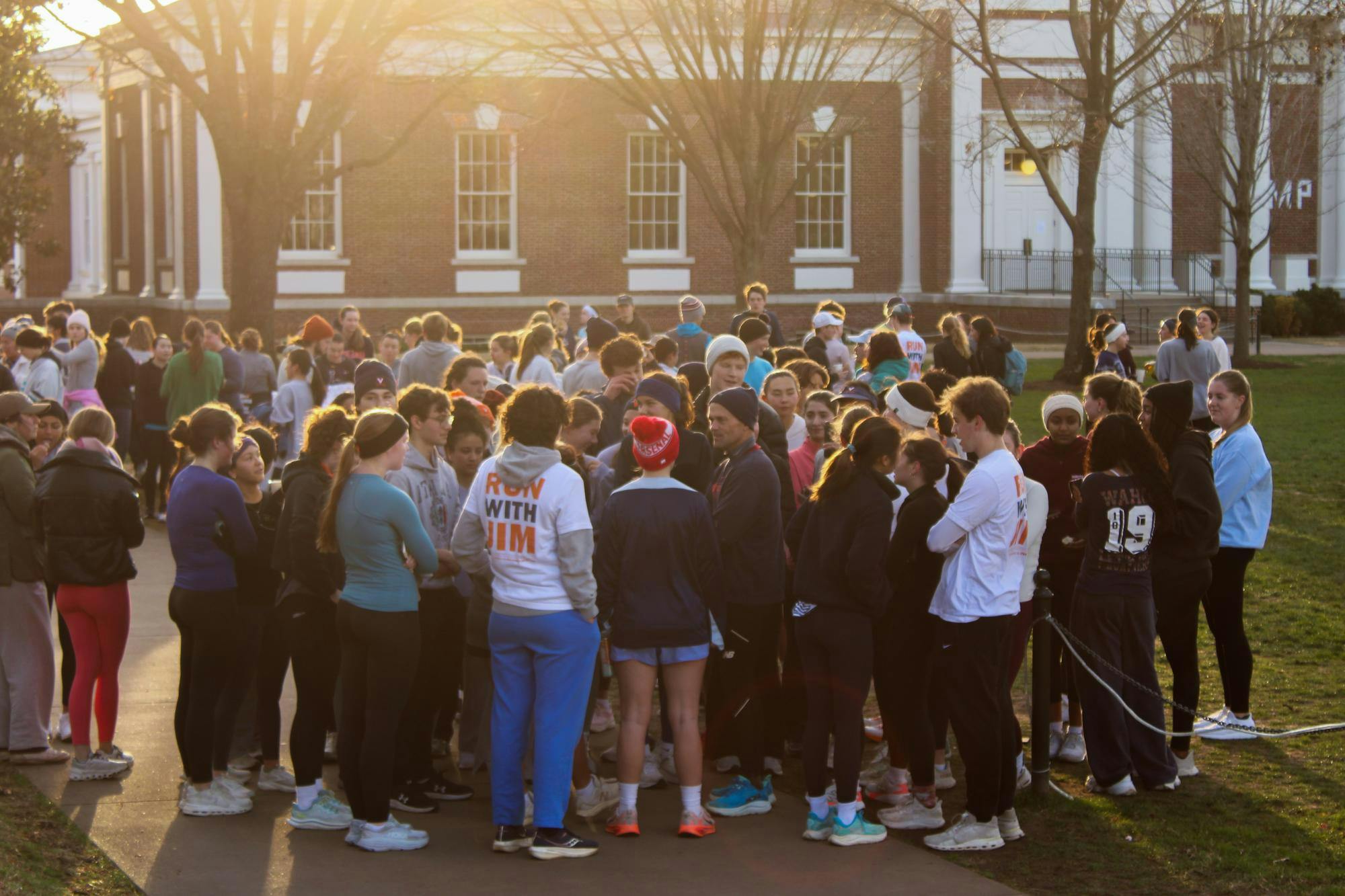 Students gather around former President Jim Ryan at South Lawn, after the "Run with Jim," photographed Dec. 4.