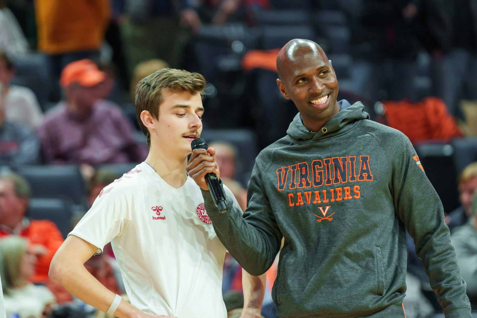 Hicks interviews a contestant during a halftime event at John Paul Jones Arena.