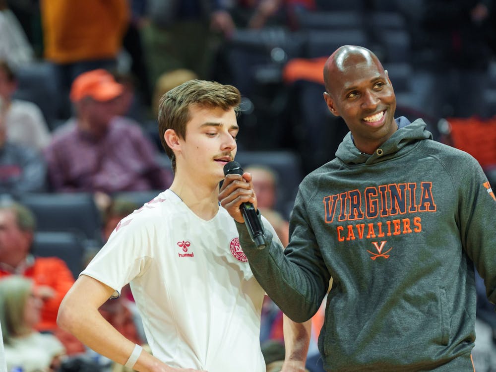 Hicks interviews a contestant during a halftime event at John Paul Jones Arena.