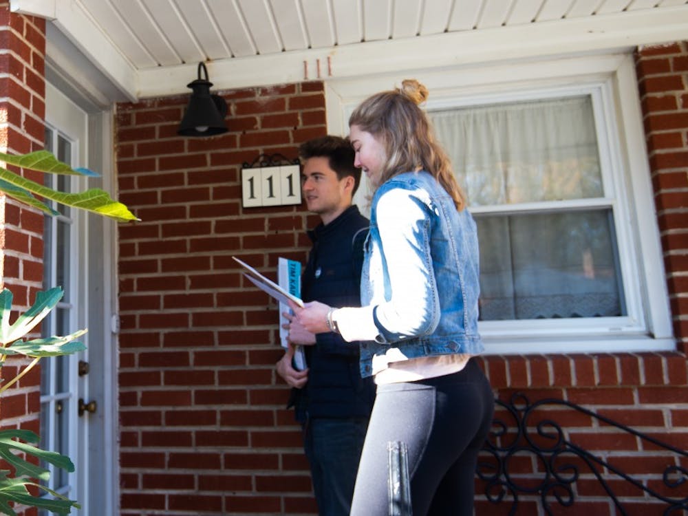Jackson Samples, University Democrats campaign chair and a third-year College student, and Mary Alice Kukoski, University Democrats President and a third-year College student, knock doors near Buford Middle School Saturday.&nbsp;