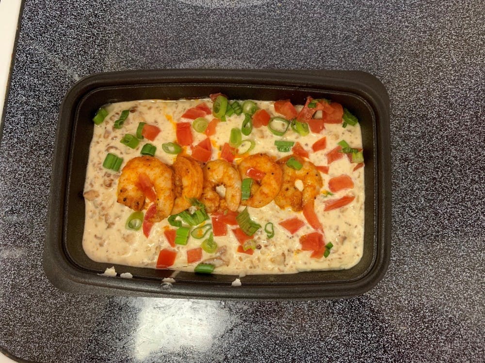 This meal comes with four shrimp, as well as sauteed bacon, tomatoes and scallions mixed in with grits. &nbsp;