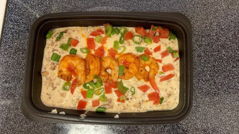 This meal comes with four shrimp, as well as sauteed bacon, tomatoes and scallions mixed in with grits. &nbsp;