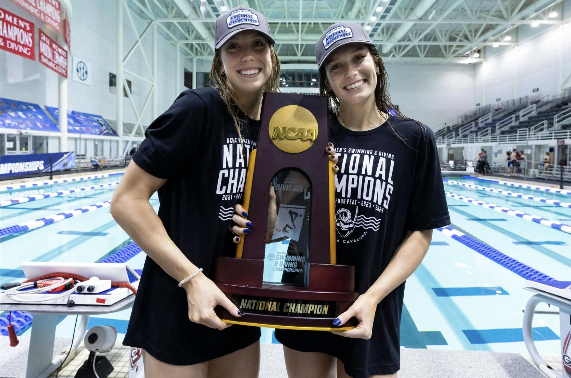 Alex and Gretchen Walsh pose with the 2024 National Championship trophy.