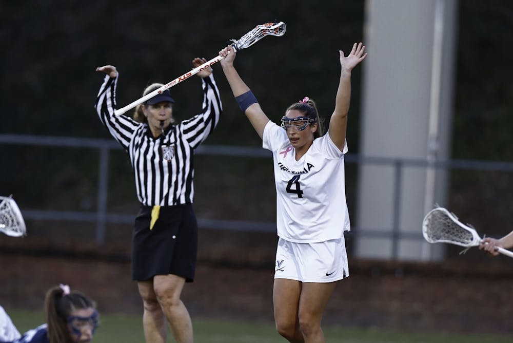 <p>Jenna Dinardo raises her arms after one of Virginia's 20 goals.</p>