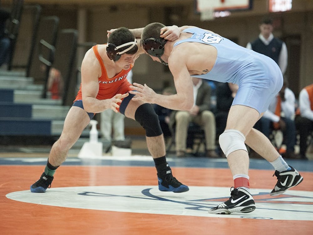 Virginia wrestling held a narrow 14-11 lead in Blacksburg before the Hokies' heavyweights rallied. 