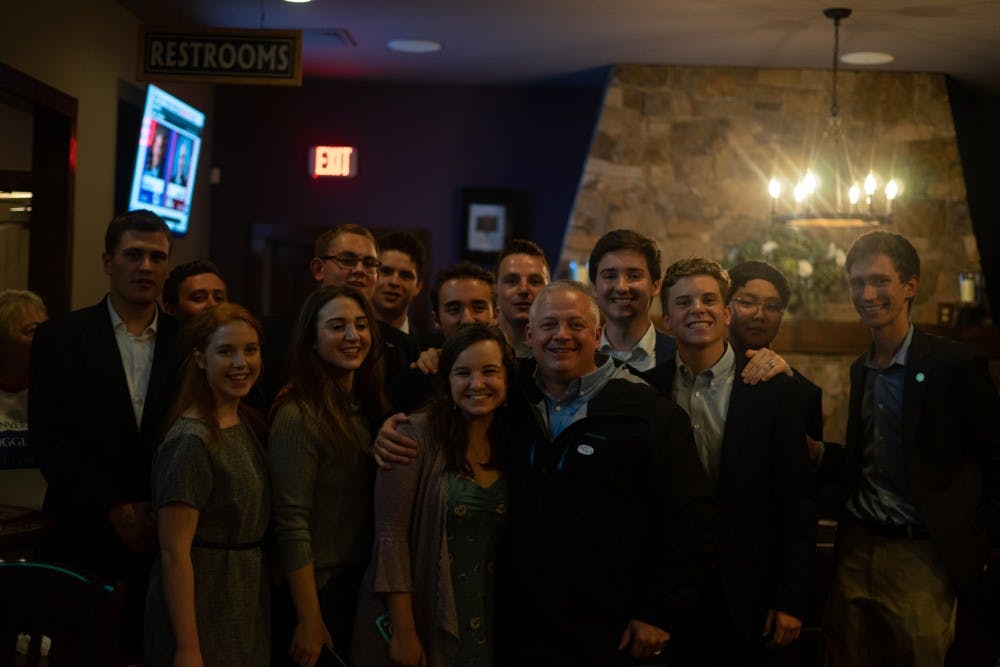 <p>Republican Denver Riggleman, who was elected to represent Virginia's Fifth Congressional District Tuesday night, poses for a photo with members of the College Republicans at his election party.&nbsp;</p>