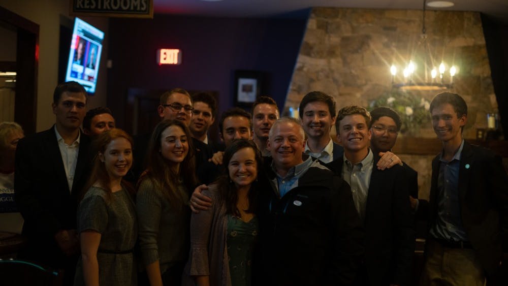 Republican Denver Riggleman, who was elected to represent Virginia's Fifth Congressional District Tuesday night, poses for a photo with members of the College Republicans at his election party.&nbsp;