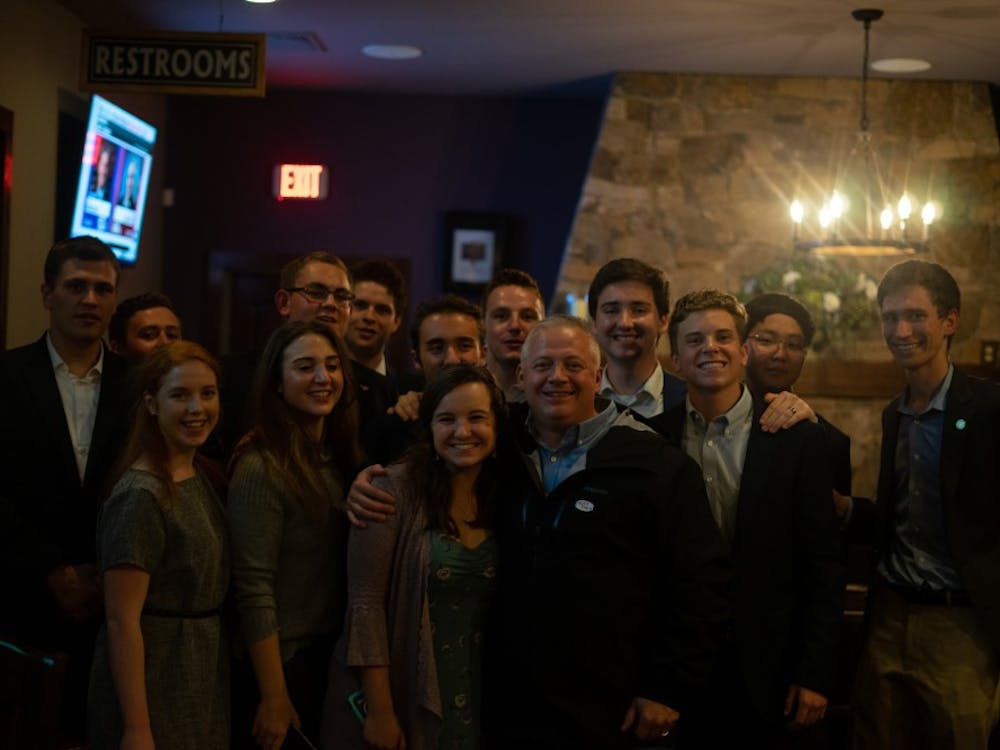 Republican Denver Riggleman, who was elected to represent Virginia's Fifth Congressional District Tuesday night, poses for a photo with members of the College Republicans at his election party.&nbsp;