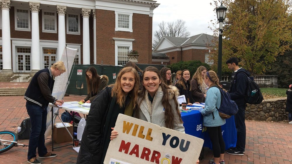 Two students hold up a sign for the bone marrow registry drive.