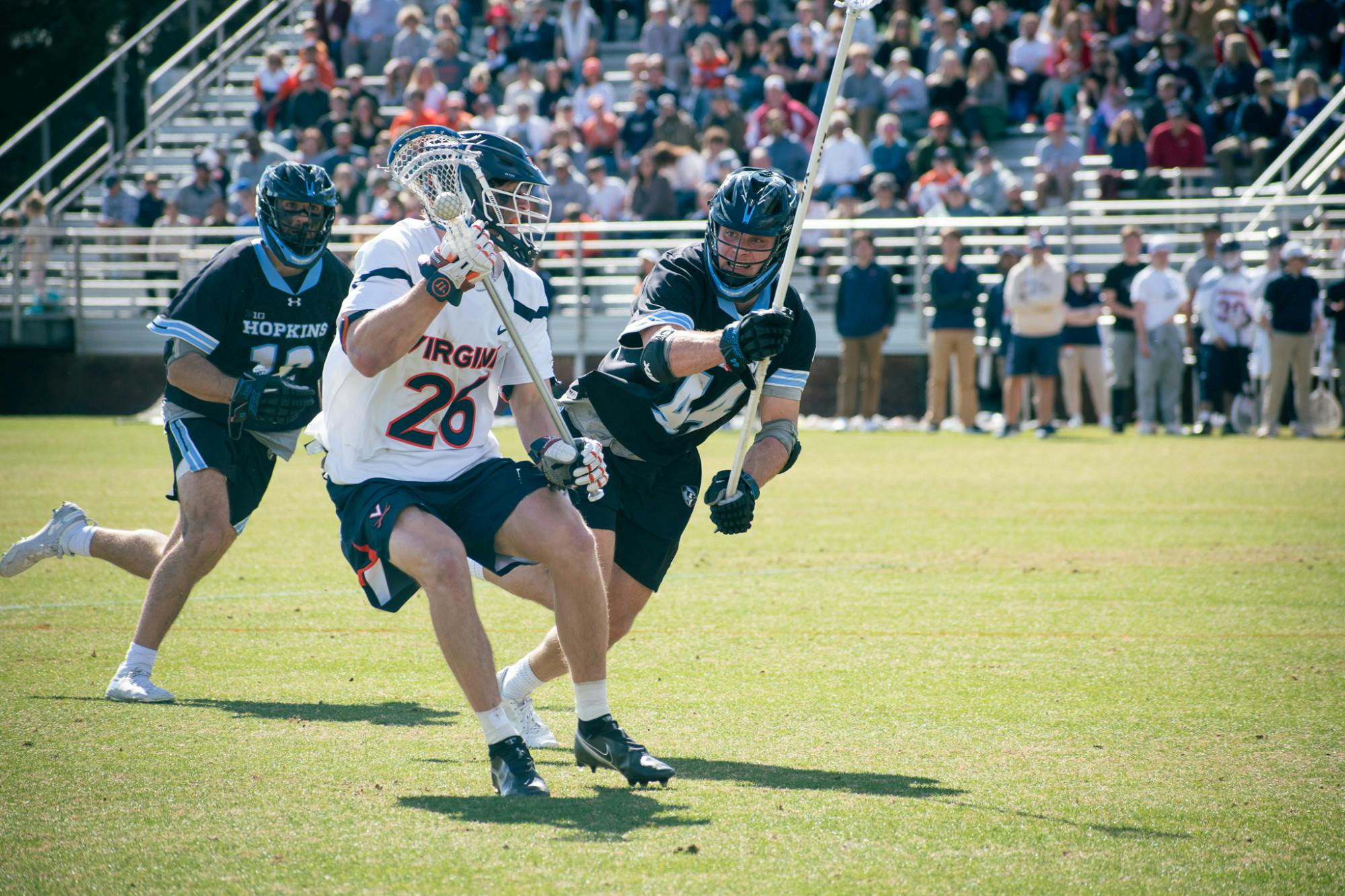 A Johns Hopkins defenseman confronts junior midfielder Griffin Schutz.