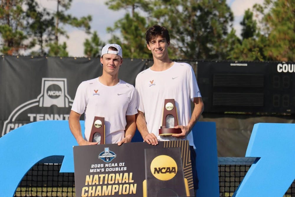 <p>The winning doubles pair poses with their trophies.</p>