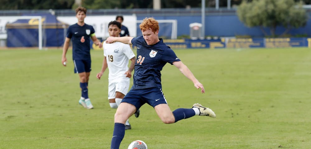 <p>Freshman midfielder Luke Burns looks to deliver a cross against California.</p>