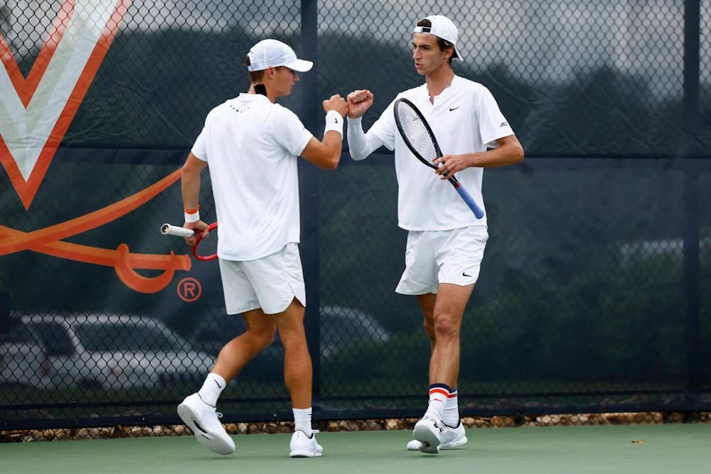 <p>Måns Dahlberg and Dylan Dietrich bump fists during a match as doubles partners.</p>
