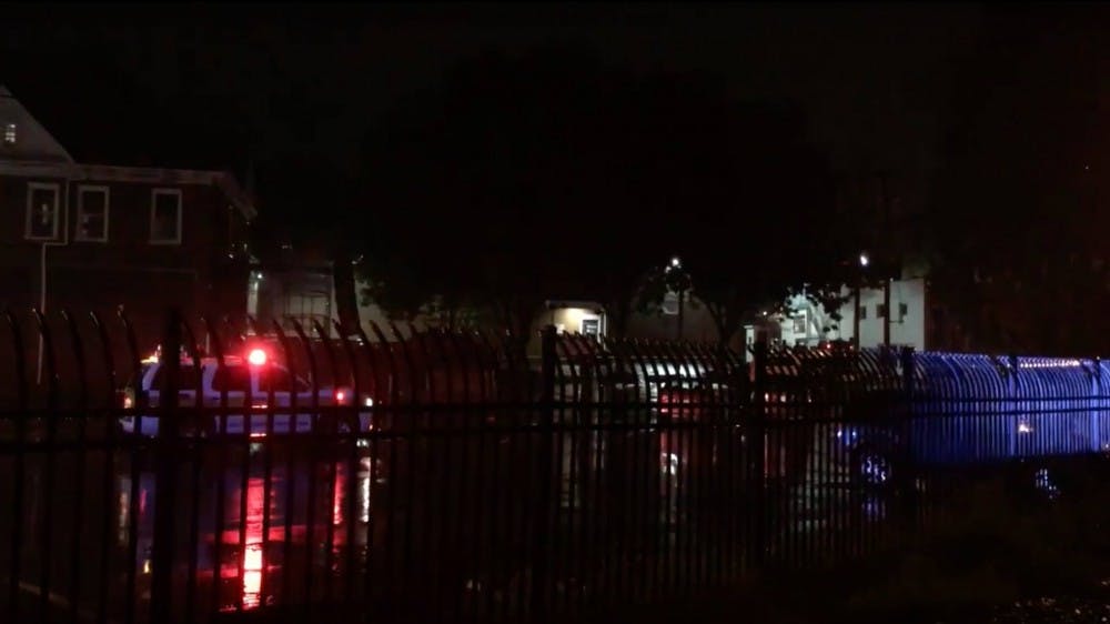 Police cars, with sirens on, waiting in the Corner Parking Lot.