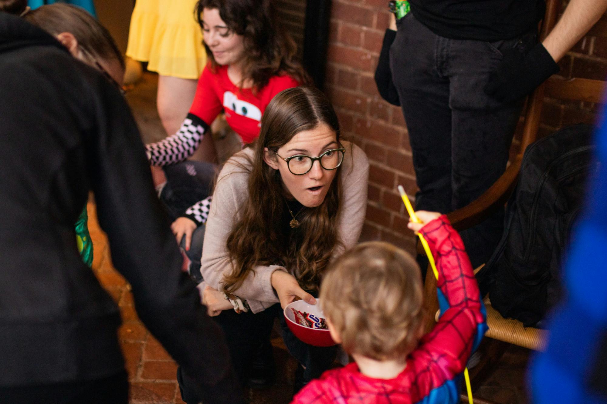 A student hands candy to a trick-or-treater at least year's TOTOTL event.&nbsp;