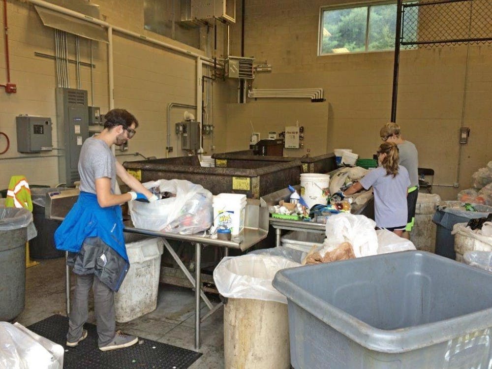 Steering away from single-stream recycling, workers in facilities management sort through bags of recycled material to further separate them to ensure cleanliness and little contamination.&nbsp;