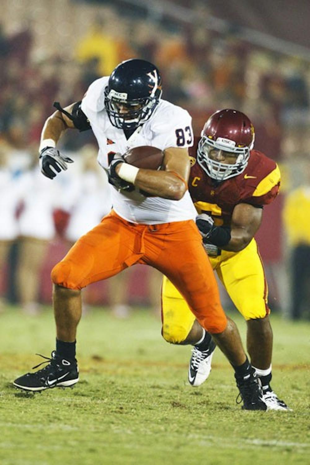 September 11, 2010; Los Angeles, CA, USA;  Virginia Cavaliers tight end Joe Torchia (83) rushes up field past Southern California Trojans linebacker Malcolm Smith (6) during the fourth quarter at the Los Angeles Memorial Coliseum. USC defeated Virginia 17-14.
