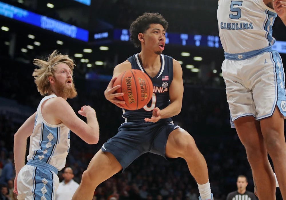 <p>Kihei Clark tries to pass around North Carolina's imposing frontcourt.</p>