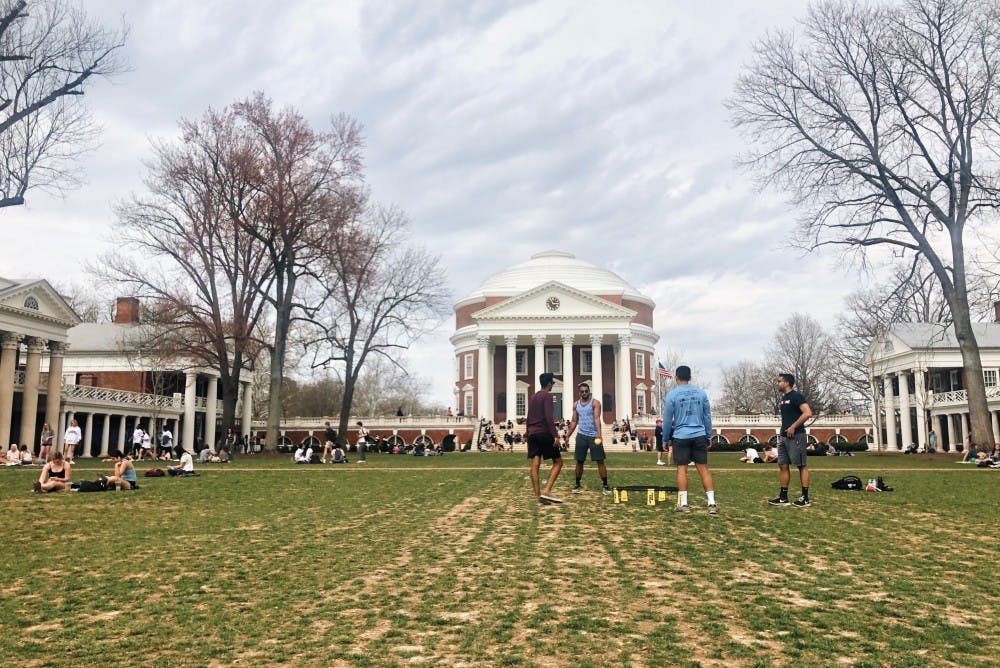 Students play spikeball on the Lawn on a spring afternoon.&nbsp;