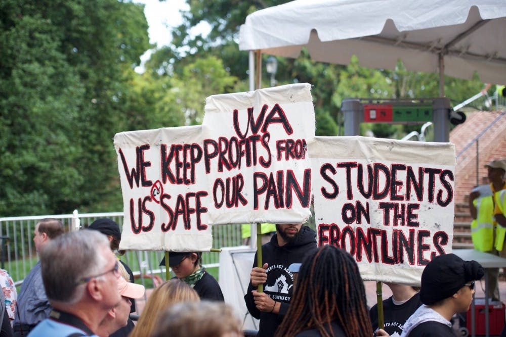 Members of U.Va. Students United stand in front of the Rotunda at the start of a rally on Saturday.&nbsp;