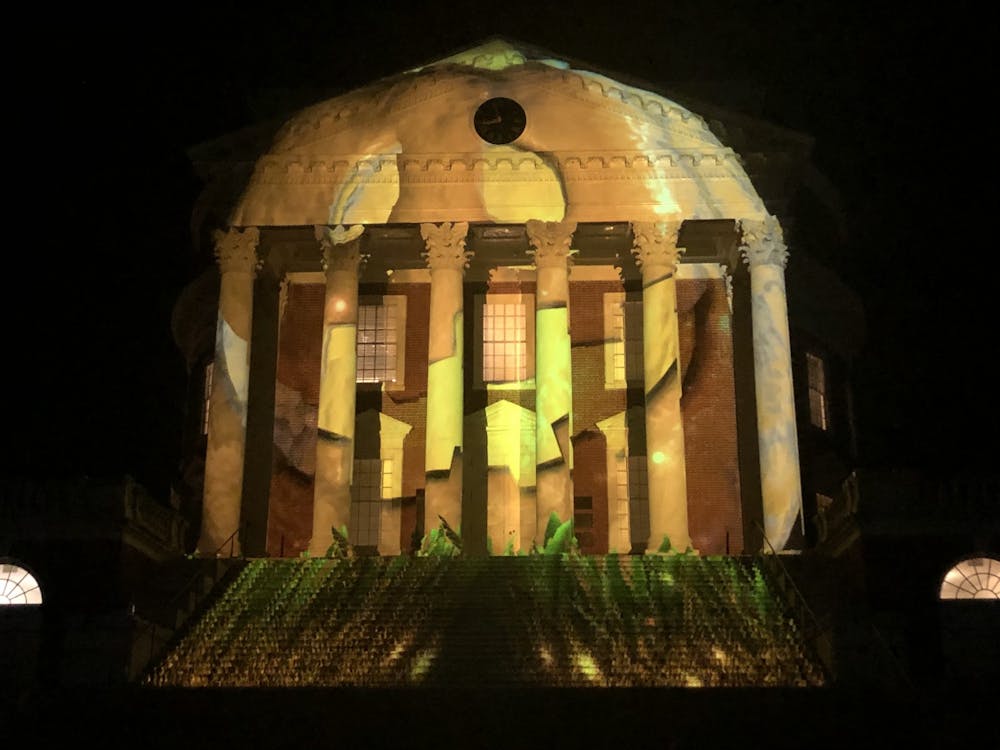 <p>The translucent columns displayed an intriguing switch from the modern Rotunda to an abandoned prehistoric stone building covered in weeds with a pumpkin and purple witch cauldron rotating across the projection.</p>