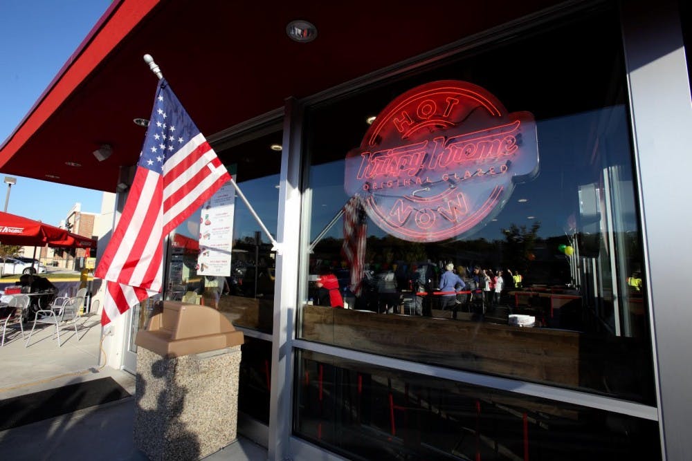 The road is curvy, but when the bright neon lights reading “Krispy Kreme” emerge, you hit the gas just a little harder.