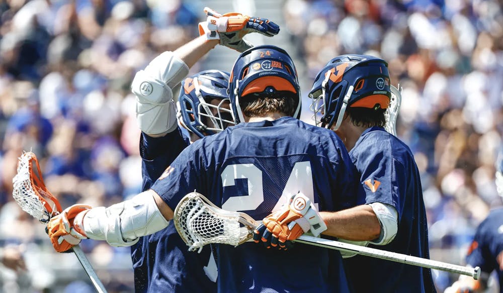 <p>Virginia attackmen cluster together on the field during Sunday's game.</p>