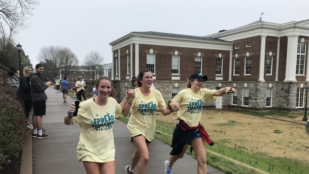 Fourth years in Pi Beta Phi, Lindsay Klein, Talley Snow and Augusta Durham, joyously cross the finish line.