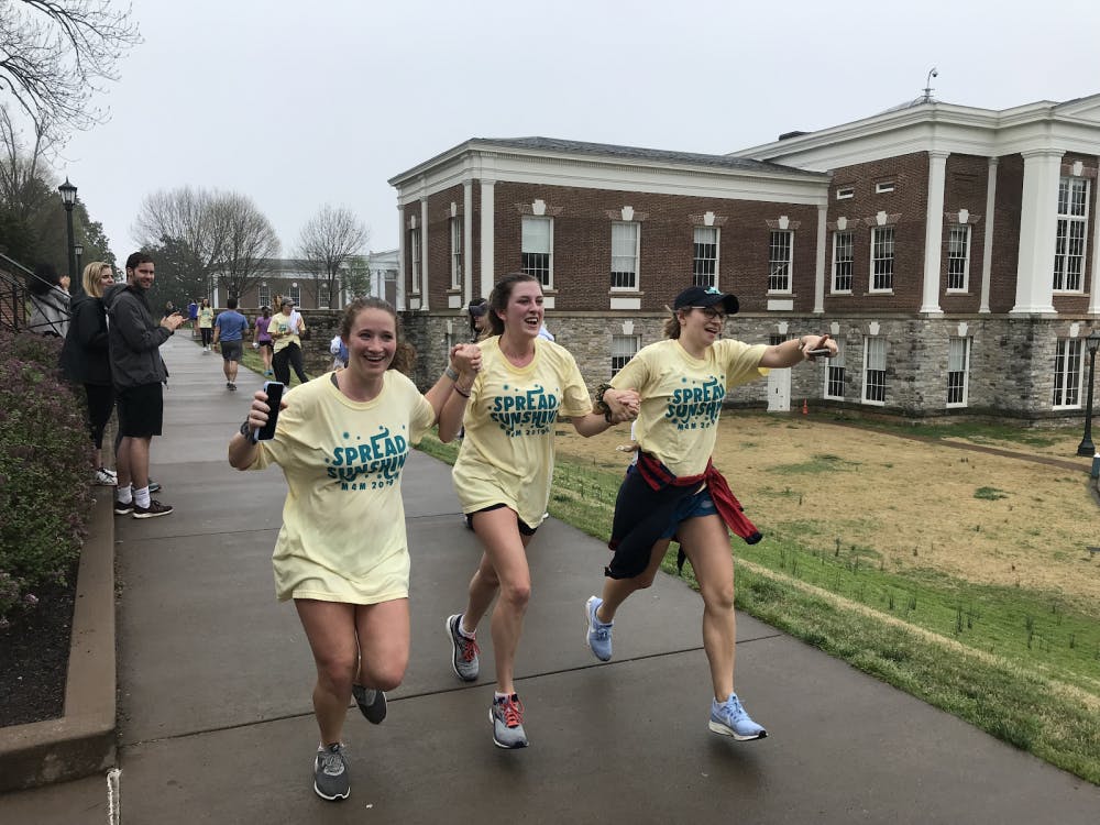 Fourth years in Pi Beta Phi, Lindsay Klein, Talley Snow and Augusta Durham, joyously cross the finish line.