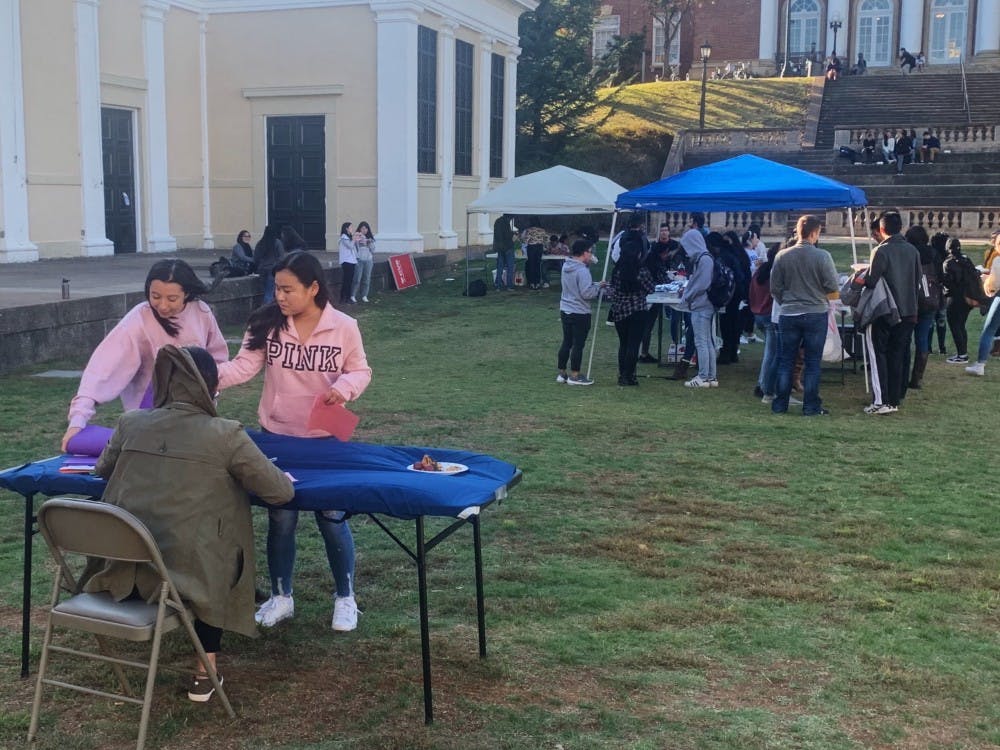 Students wandered throughout the windy Amphitheater Thursday, sporting both bandaids on their shoulders and a plate full of traditional Indian dishes in their hands. &nbsp;