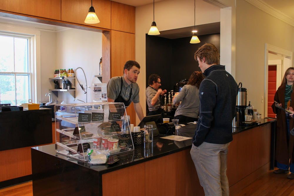 <p>Warmth fills the new cafe as customers pile in, sitting on couches next to a fireplace, talking to their neighbors and with the staff.</p>