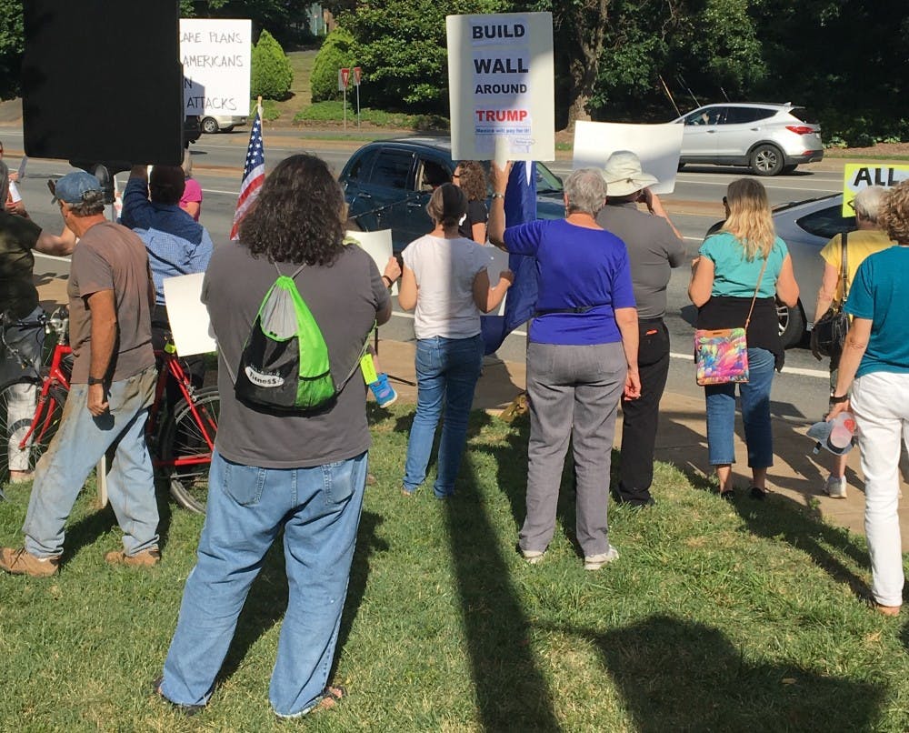 Representatives from political advocacy groups, local candidates and politicians spoke in front of about a hundred protesters.