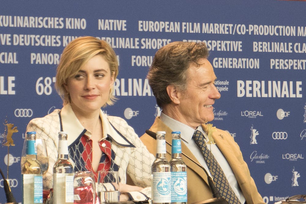 Director Greta Gerwig in 2018 at a press event for the Wes Anderson film "Isle of Dogs," alongside actor Bryan Cranston. &nbsp;