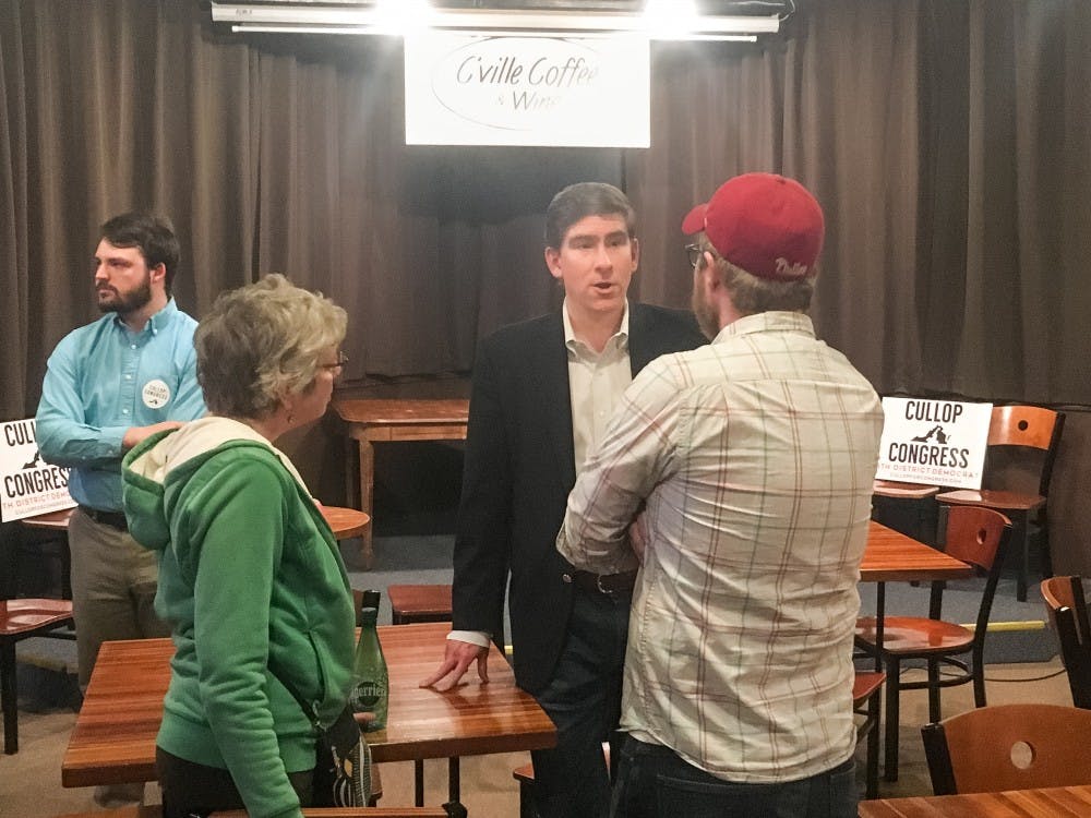 <p>Democratic candidate for Virginia's Fifth Congressional District Ben Cullop (center) speaks with attendees at a campaign meet and greet in Charlottesville Tuesday.&nbsp;</p>