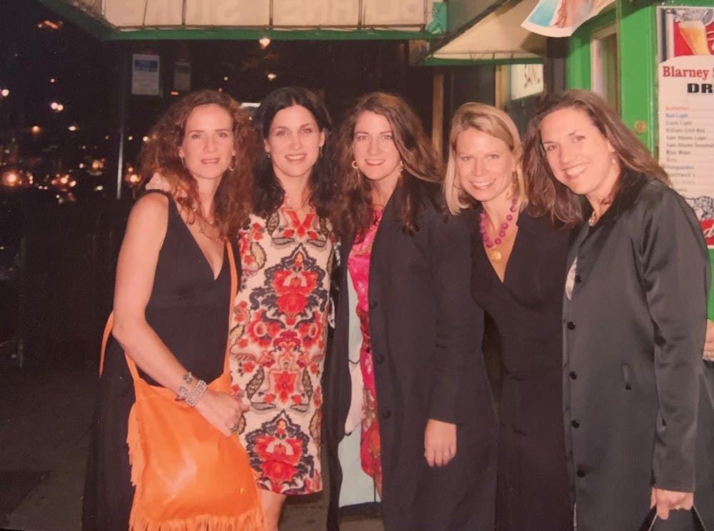 <p>Laura Marshall, pictured center, alongside four friends from her time with Virginia track and field. </p>