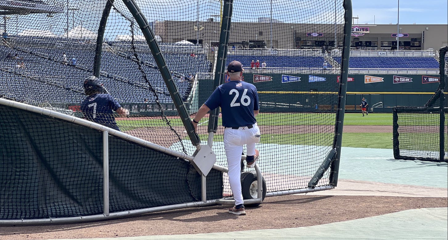 Coach Brian O'Connor watches as then-sophomore utility player Aidan Teel practices for the 2024 College World Series.