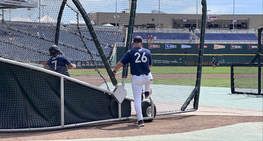 Coach Brian O'Connor watches as then-sophomore utility player Aidan Teel practices for the 2024 College World Series.