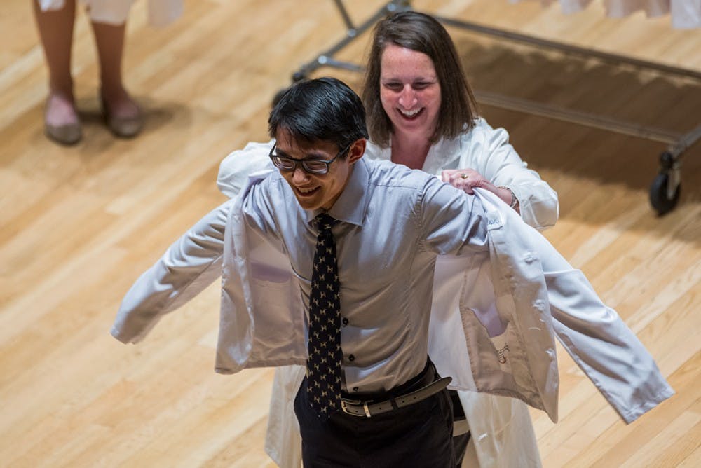 <p>Students are officially welcomed to the School of Medicine by receiving a personally-embroidered white coat.</p>