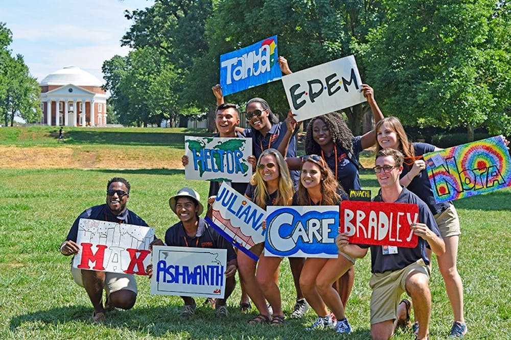 <p>Orientation leaders show off their signs.</p>
