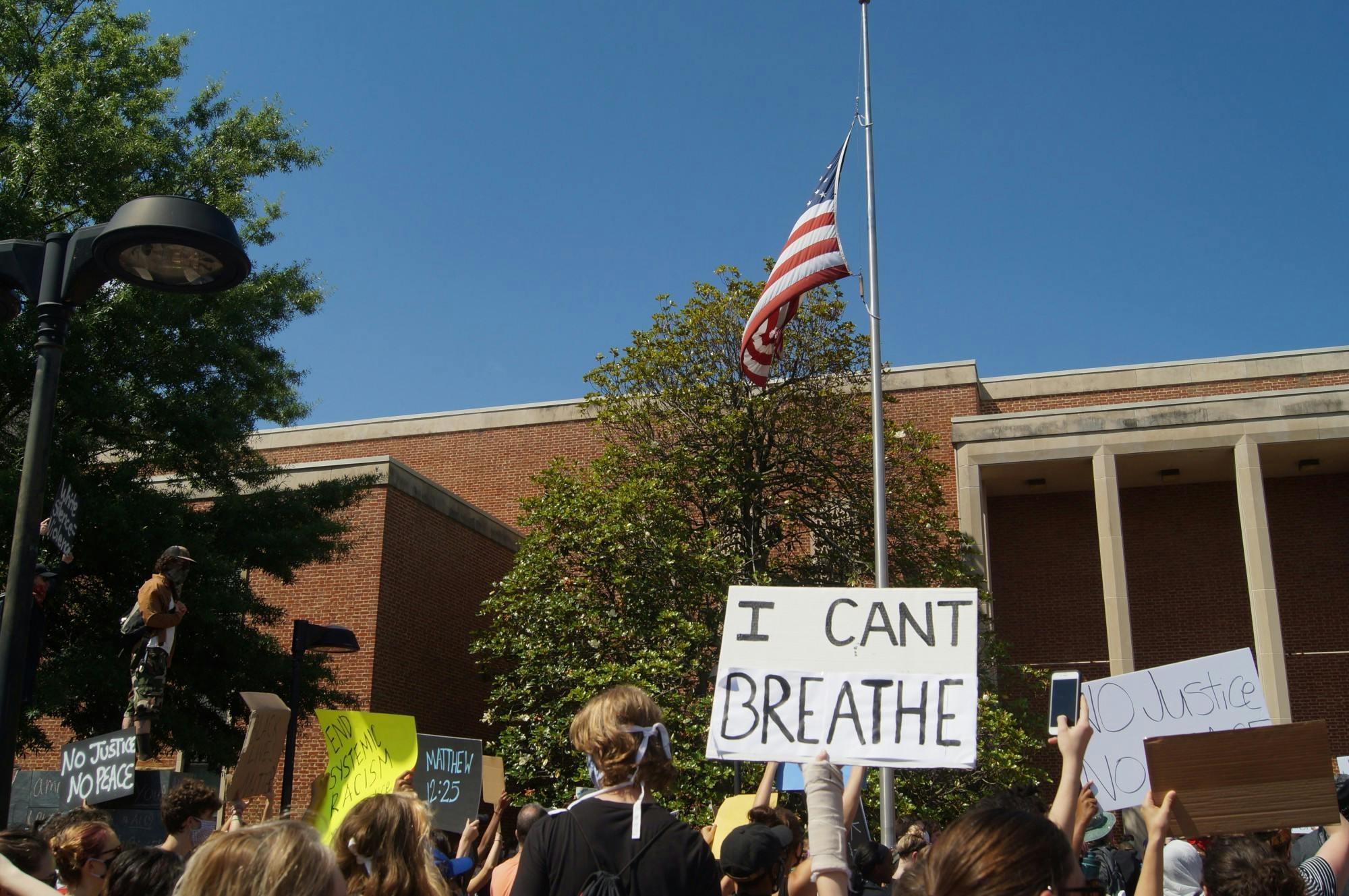 Hundreds of community members peacefully gathered near the Downtown Mall holding signs condemning racialized police violence.