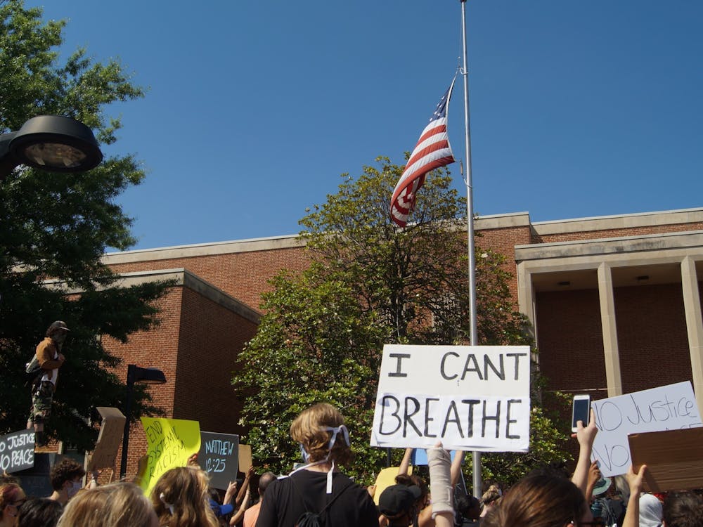 Hundreds of community members peacefully gathered near the Downtown Mall holding signs condemning racialized police violence.