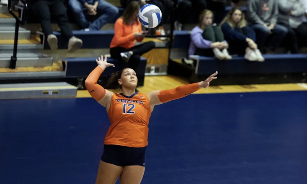 <p>Kadynce Boothe leaps to strike a serve.</p>