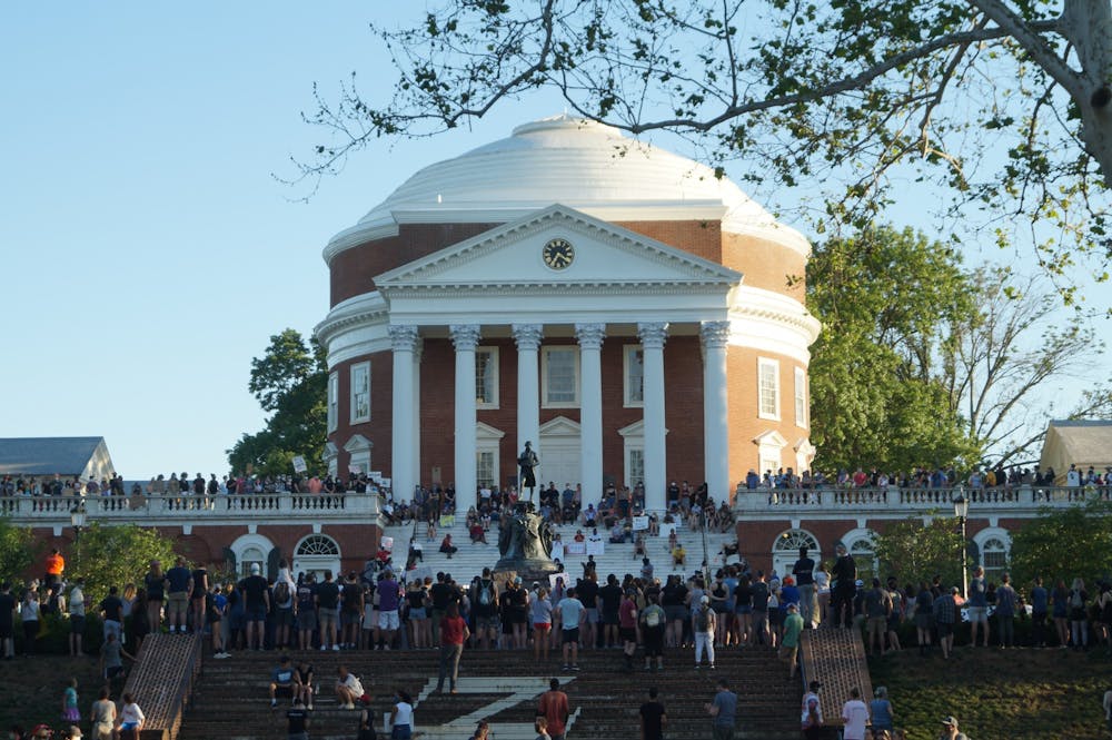 Hundreds of community members marched from the Downtown Mall to the U.Va. Rotunda in a peaceful rally advocating for the removal of Confederate monuments in Charlottesville. (CD Photo // Sophie Roehse)&nbsp;