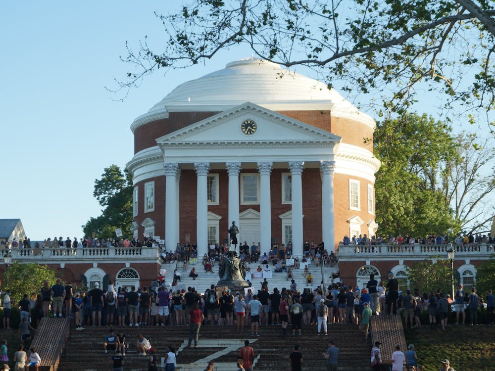 Hundreds of community members marched from the Downtown Mall to the U.Va. Rotunda in a peaceful rally advocating for the removal of Confederate monuments in Charlottesville. (CD Photo // Sophie Roehse)&nbsp;