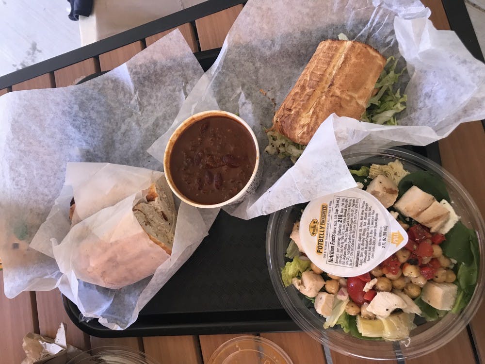 From left to right, a whole tuna sub, a cup of chili, half of a turkey club sandwich and Mediterranean salad.&nbsp;