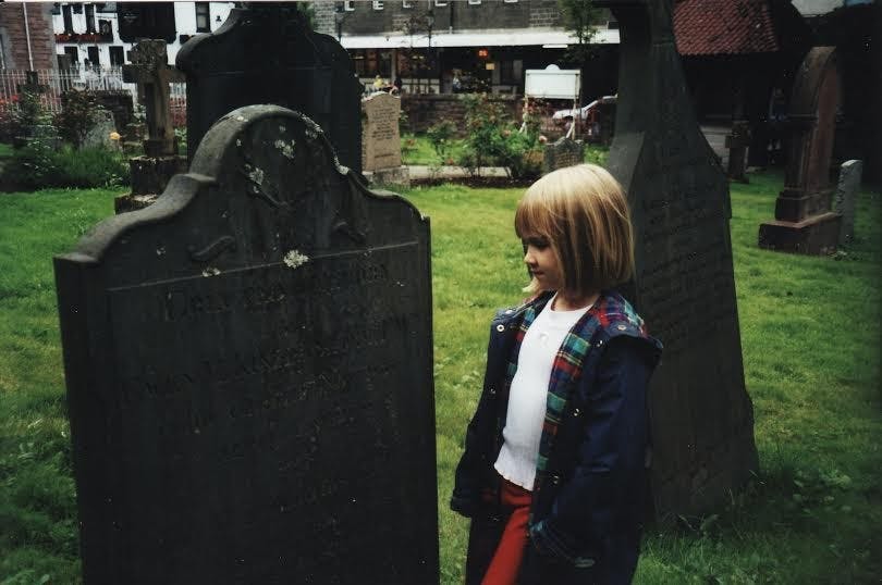 Tori Travers explores a graveyard in Scotland at the age of five.