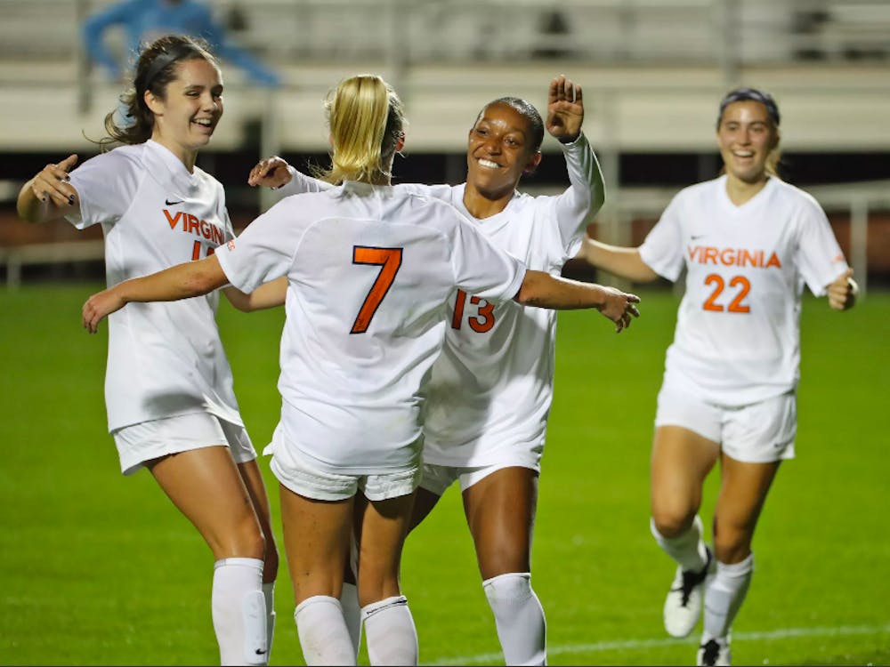 The Cavaliers celebrate an early goal by junior forward Alexa Spaanstra, who guided the team to a 2-0 win against No. 13 Louisville Thursday night.&nbsp;